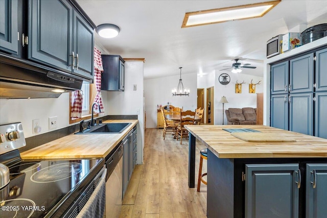 kitchen featuring a center island, hanging light fixtures, appliances with stainless steel finishes, a sink, and blue cabinets