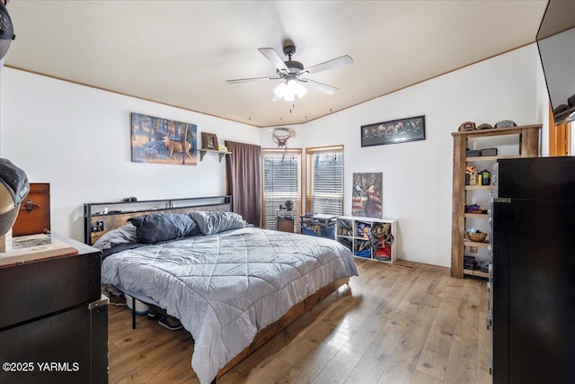 bedroom featuring light wood-type flooring and ceiling fan