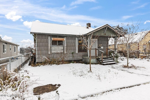 view of front of home featuring fence