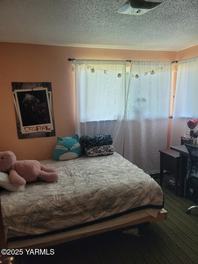 carpeted bedroom featuring a textured ceiling