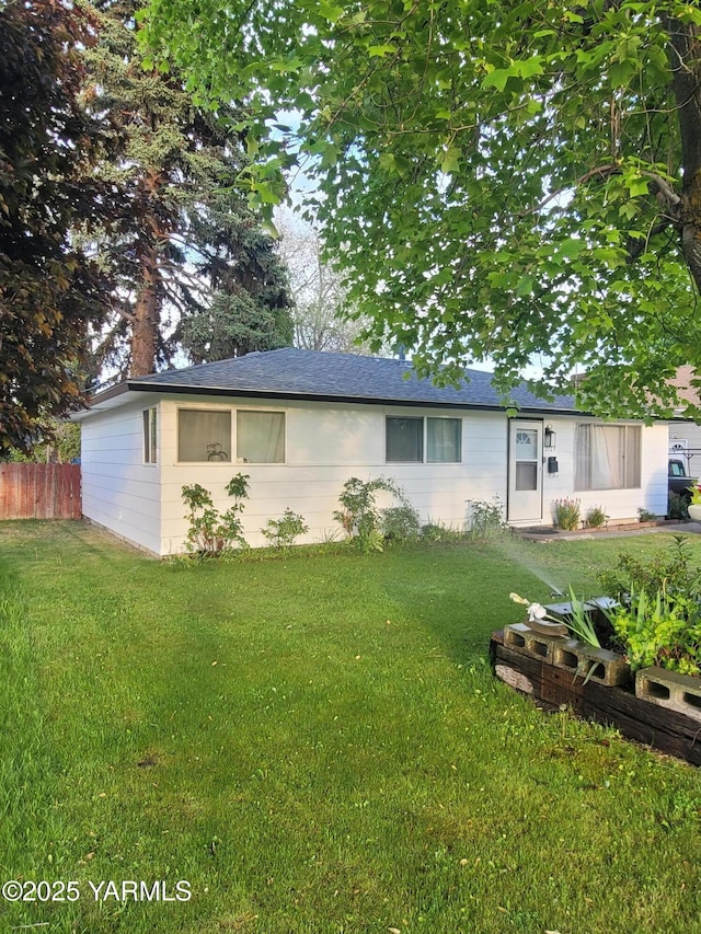 rear view of property with a shingled roof