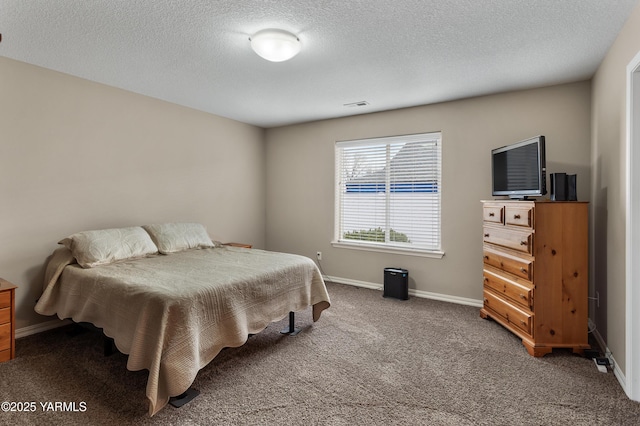 carpeted bedroom with visible vents, baseboards, and a textured ceiling