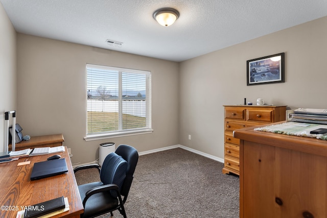 office area featuring visible vents, carpet flooring, a textured ceiling, and baseboards