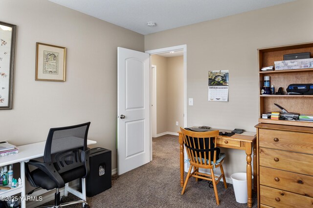 carpeted office featuring baseboards