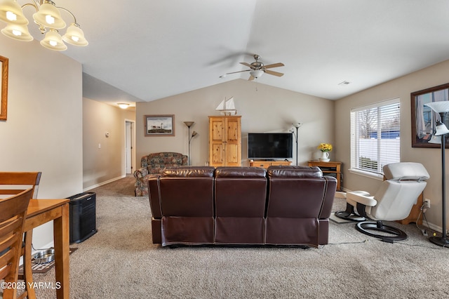 carpeted living area featuring vaulted ceiling, ceiling fan with notable chandelier, baseboards, and visible vents