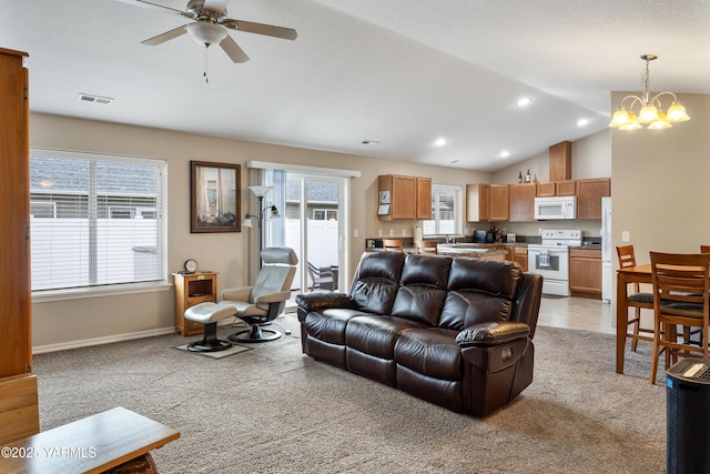 living area with visible vents, recessed lighting, baseboards, light colored carpet, and vaulted ceiling