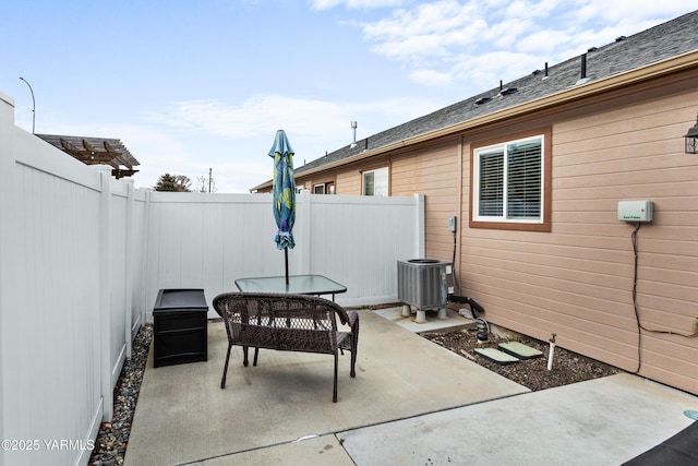 view of patio with cooling unit and a fenced backyard