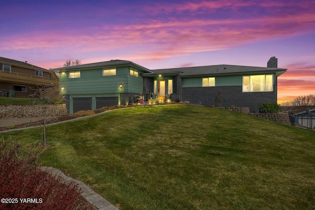 419 N 62nd Ave, Yakima, WA 98908 - split level home with a garage, a chimney, and a front yard