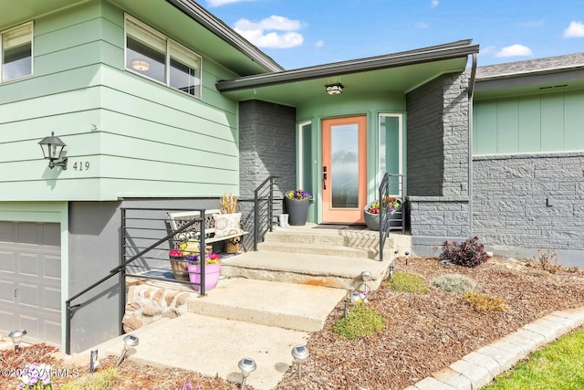 419 N 62nd Ave, Yakima, WA 98908 - doorway to property featuring stone siding and a garage