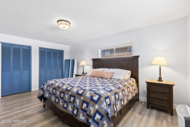 419 N 62nd Ave, Yakima, WA 98908 - bedroom featuring baseboards, wood finished floors, and two closets