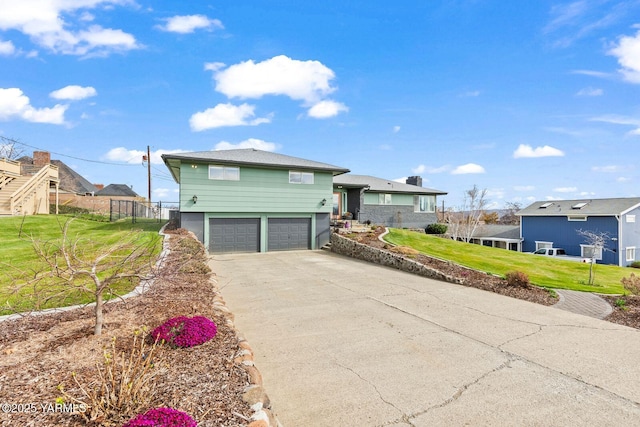 419 N 62nd Ave, Yakima, WA 98908 - split level home featuring a residential view, driveway, fence, an attached garage, and a front yard