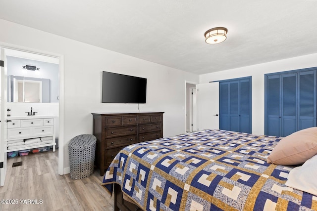 419 N 62nd Ave, Yakima, WA 98908 - bedroom featuring ensuite bathroom, light wood-style floors, and two closets