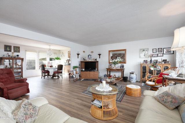 living area with an inviting chandelier and wood finished floors