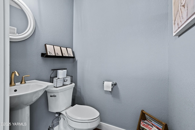 half bath with a sink and toilet