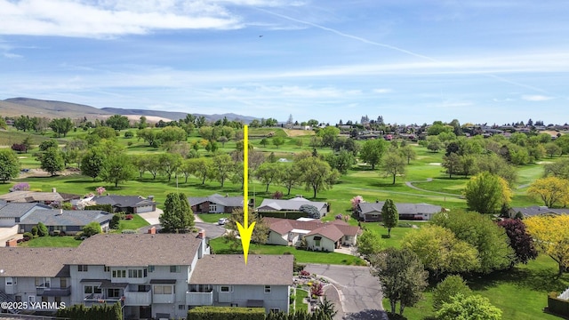 drone / aerial view with a residential view, a mountain view, and view of golf course