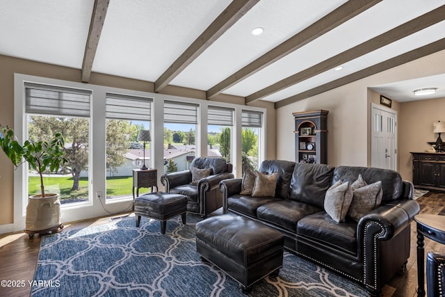 living area with recessed lighting, a wealth of natural light, vaulted ceiling with beams, and wood finished floors