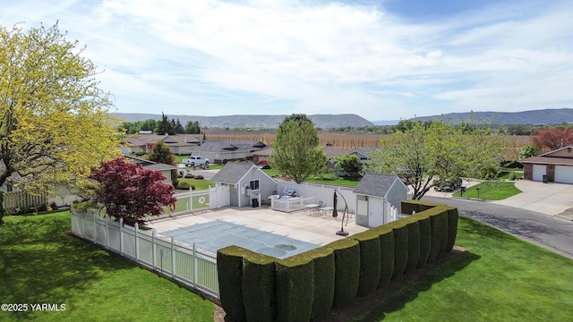 exterior space with an outdoor structure, a yard, a shed, and a fenced backyard