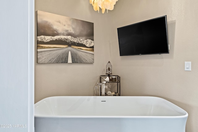 full bath featuring a freestanding tub
