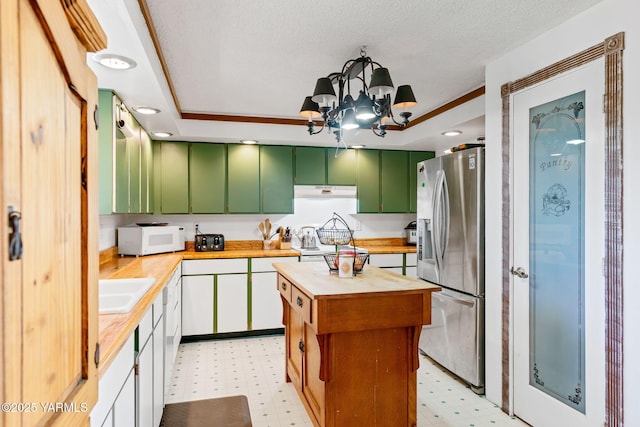 1620 Selah Loop Rd, Selah, WA 98942 - kitchen featuring green cabinetry, stainless steel fridge, white microwave, light floors, and wood counters