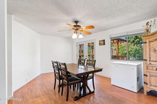 1620 Selah Loop Rd, Selah, WA 98942 - dining space with french doors, light wood-type flooring, a textured ceiling, and ceiling fan