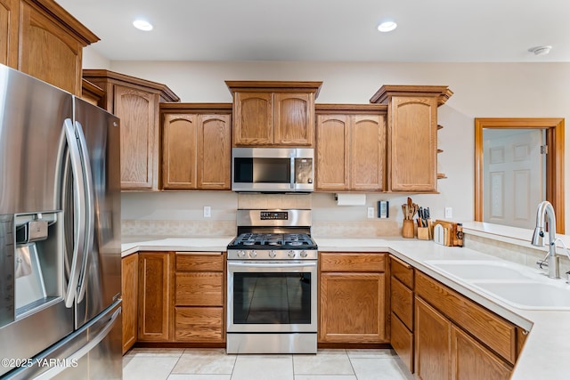 9307 Torrey Pines Ln, Yakima, WA 98908 - kitchen featuring stainless steel appliances, light countertops, brown cabinetry, and recessed lighting