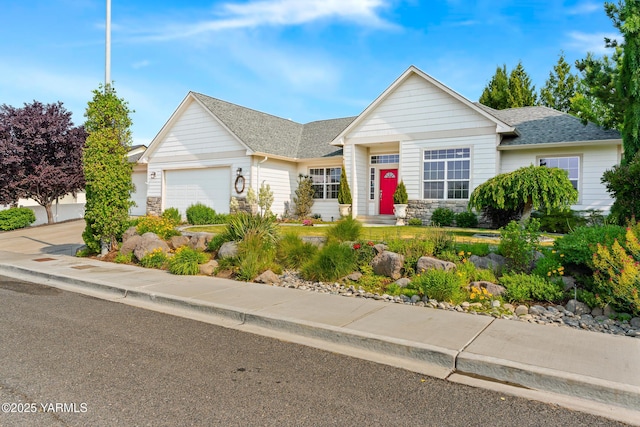 9307 Torrey Pines Ln, Yakima, WA 98908 - view of front of property with stone siding, an attached garage, a shingled roof, and concrete driveway