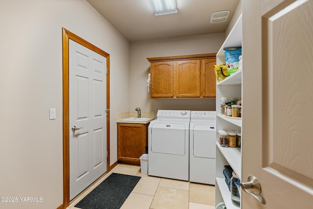 9307 Torrey Pines Ln, Yakima, WA 98908 - washroom with washing machine and clothes dryer, cabinet space, and light tile patterned floors
