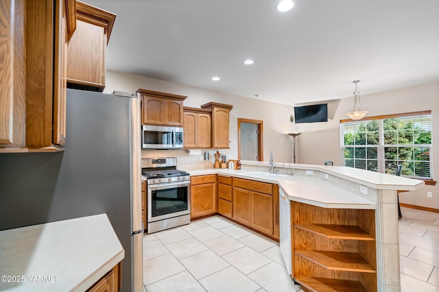 9307 Torrey Pines Ln, Yakima, WA 98908 - kitchen featuring stainless steel appliances, a peninsula, light tile patterned floors, light countertops, and recessed lighting