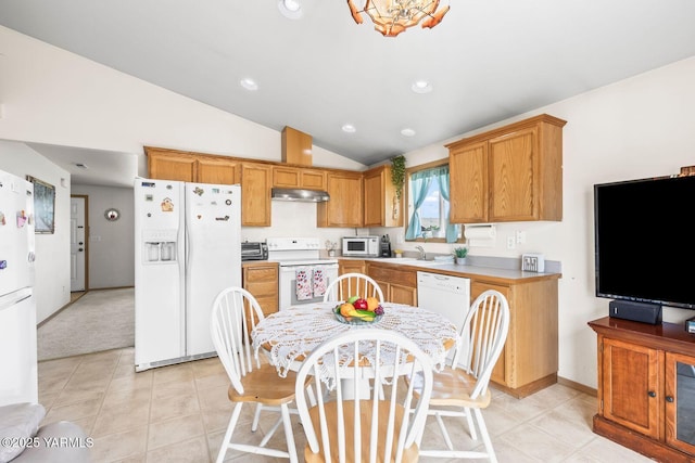 101 Darland Ave, Moxee, WA 98936 - kitchen featuring white appliances, lofted ceiling, under cabinet range hood, light countertops, and light tile patterned flooring
