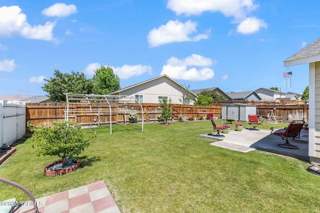 101 Darland Ave, Moxee, WA 98936 - fenced backyard featuring a storage unit and a patio area