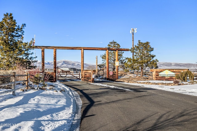 view of street featuring a gate and a mountain view