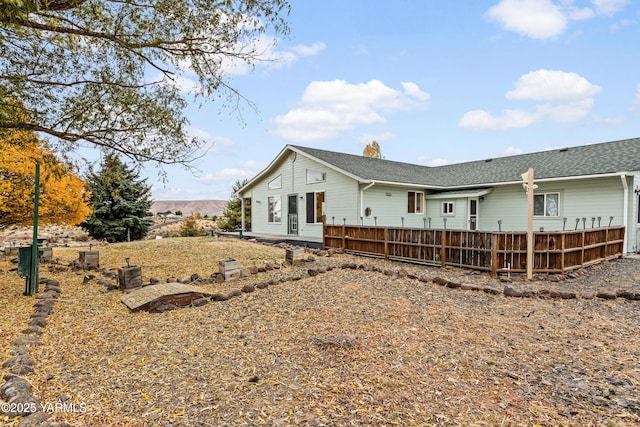 back of house featuring fence