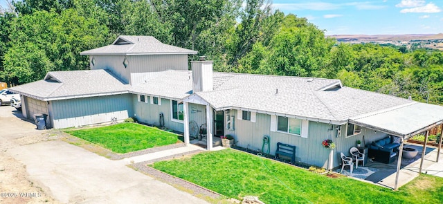 1391 Lancaster Rd, Selah, WA 98942 - view of front of home featuring a chimney, a front yard, driveway, and a garage