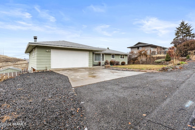 ranch-style home with driveway and a garage