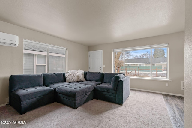 living area with a wall unit AC and baseboards