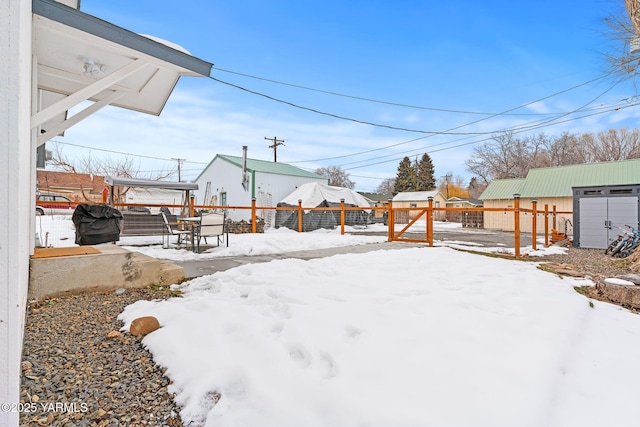 yard layered in snow with fence