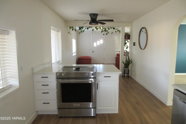 kitchen with white cabinetry, light countertops, wood finished floors, and stainless steel appliances