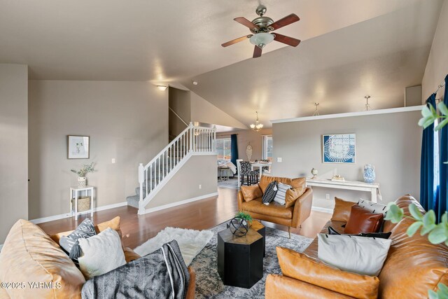 living area with baseboards, stairs, lofted ceiling, wood finished floors, and a ceiling fan