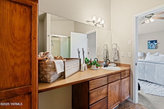 ensuite bathroom featuring tile patterned flooring, connected bathroom, vanity, and ceiling fan