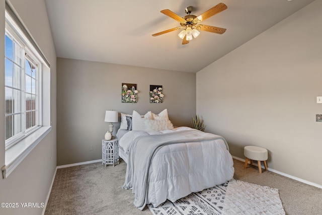 bedroom with light carpet, baseboards, and vaulted ceiling