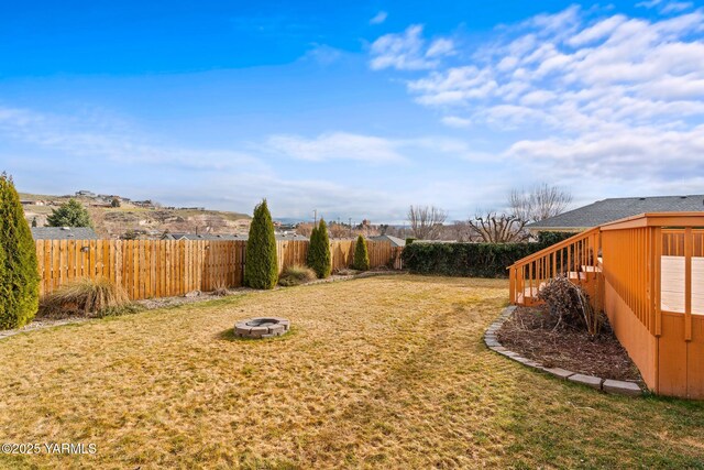 view of yard with a fire pit and a fenced backyard