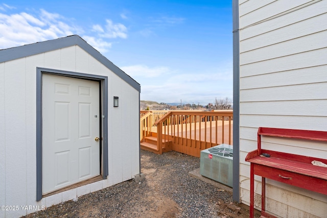 property entrance featuring a deck and central AC unit