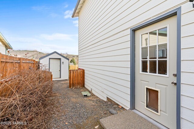 exterior space with an outdoor structure, a storage unit, and fence