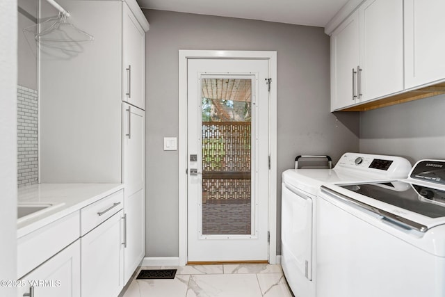 5709 Marilane St, Yakima, WA 98908 - laundry area featuring cabinet space, separate washer and dryer, and light marble finish flooring