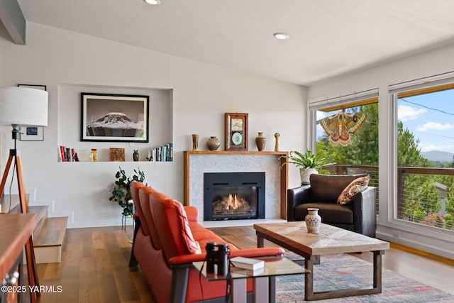 5709 Marilane St, Yakima, WA 98908 - living area with wood finished floors, recessed lighting, a glass covered fireplace, and lofted ceiling