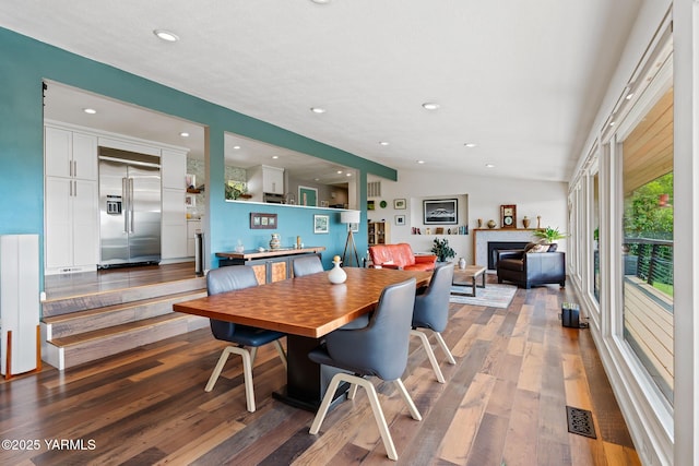 5709 Marilane St, Yakima, WA 98908 - dining area featuring a glass covered fireplace, wood finished floors, recessed lighting, and vaulted ceiling