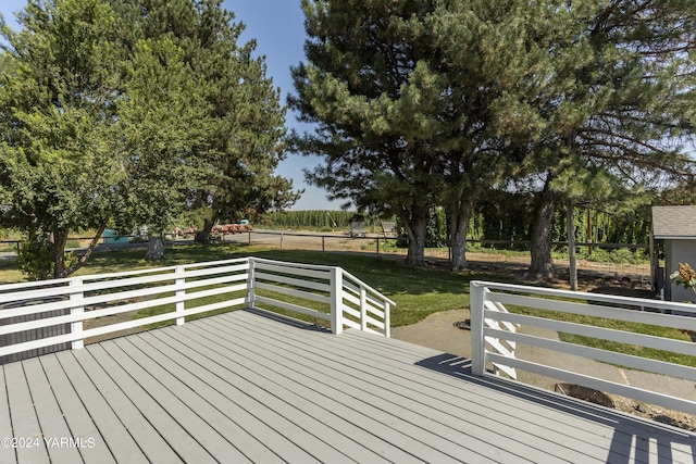 wooden terrace with a yard and fence