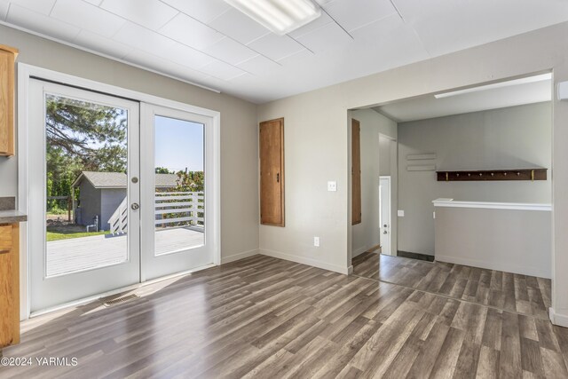 interior space featuring visible vents, baseboards, dark wood-style flooring, and french doors
