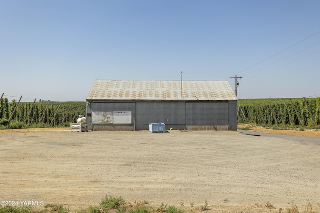 view of outbuilding with an outbuilding, a rural view, and central air condition unit