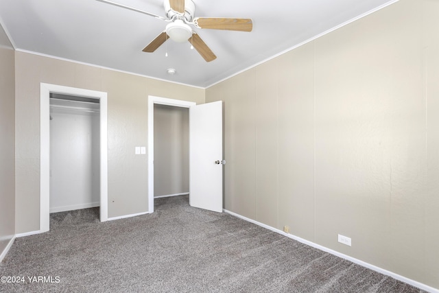 unfurnished bedroom with a ceiling fan, carpet, a closet, and crown molding